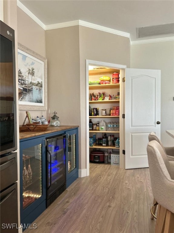 storage area with wine cooler and visible vents