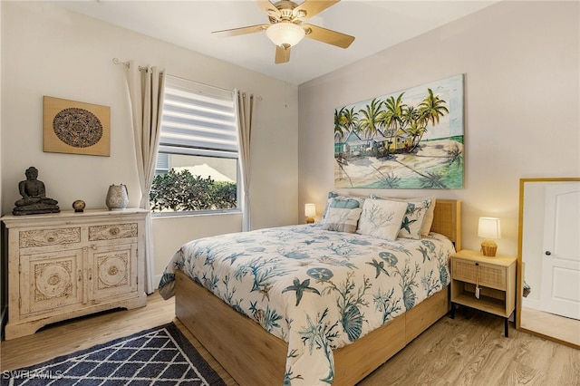 bedroom with light wood-style floors and a ceiling fan