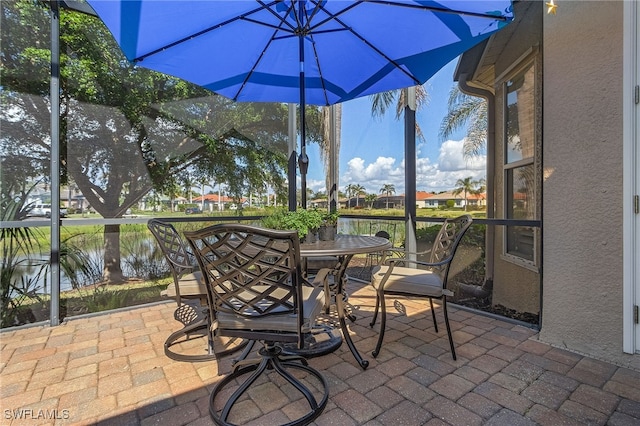 view of patio / terrace with outdoor dining area and a water view