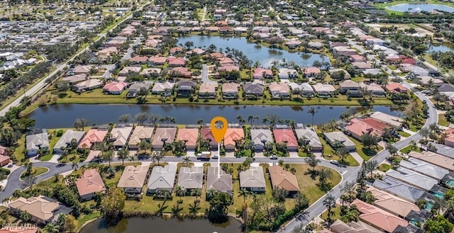 drone / aerial view with a water view and a residential view
