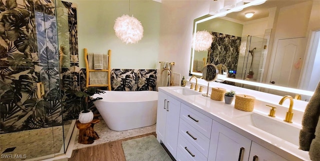 bathroom with a stall shower, a sink, and a soaking tub