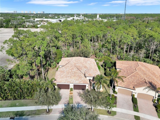 drone / aerial view featuring a forest view