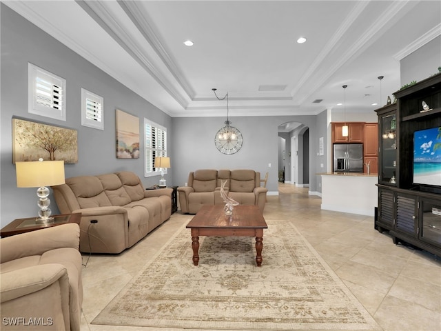 living room with light tile patterned floors, baseboards, arched walkways, ornamental molding, and a tray ceiling