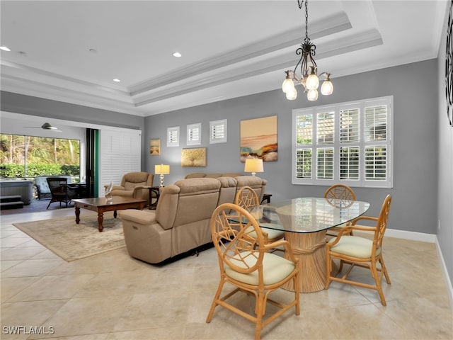 dining area with ornamental molding, a raised ceiling, and light tile patterned flooring