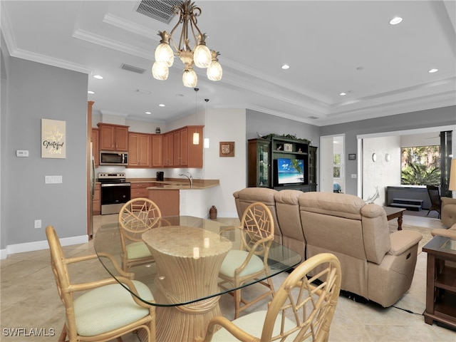 dining area with a tray ceiling, crown molding, recessed lighting, visible vents, and an inviting chandelier