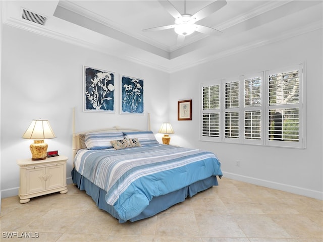 bedroom with a tray ceiling, visible vents, ornamental molding, ceiling fan, and baseboards