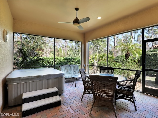 sunroom / solarium featuring a hot tub and ceiling fan