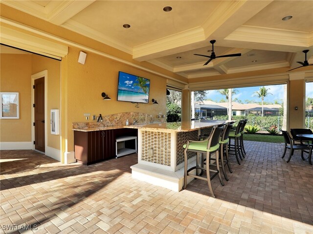 view of patio featuring outdoor dry bar and a ceiling fan