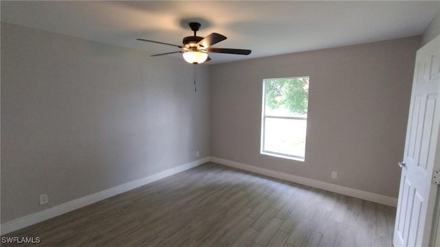 spare room with hardwood / wood-style flooring and ceiling fan