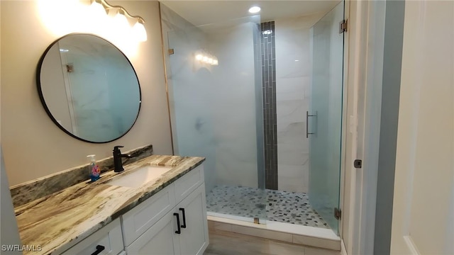 bathroom with walk in shower and vanity