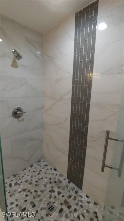 bathroom with a shower with door