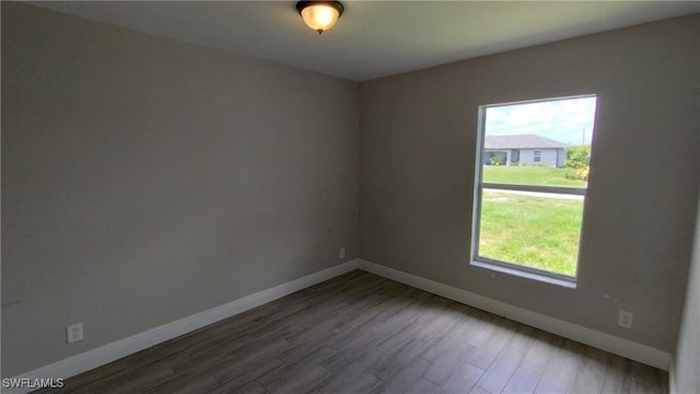 unfurnished room with wood-type flooring