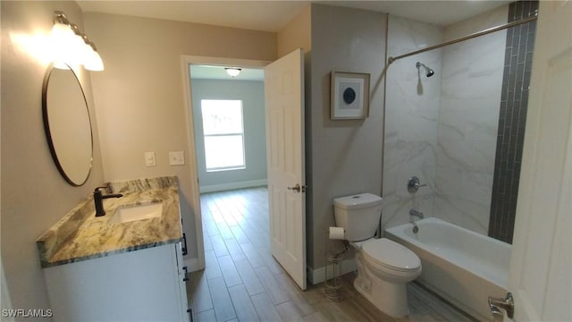 full bathroom featuring vanity, toilet, and tiled shower / bath