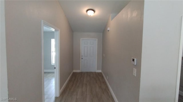 hallway with light hardwood / wood-style flooring