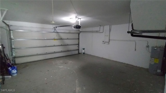 garage with water heater and a garage door opener