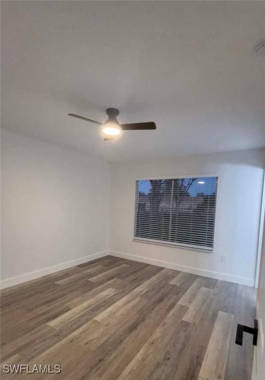 empty room featuring hardwood / wood-style floors and ceiling fan