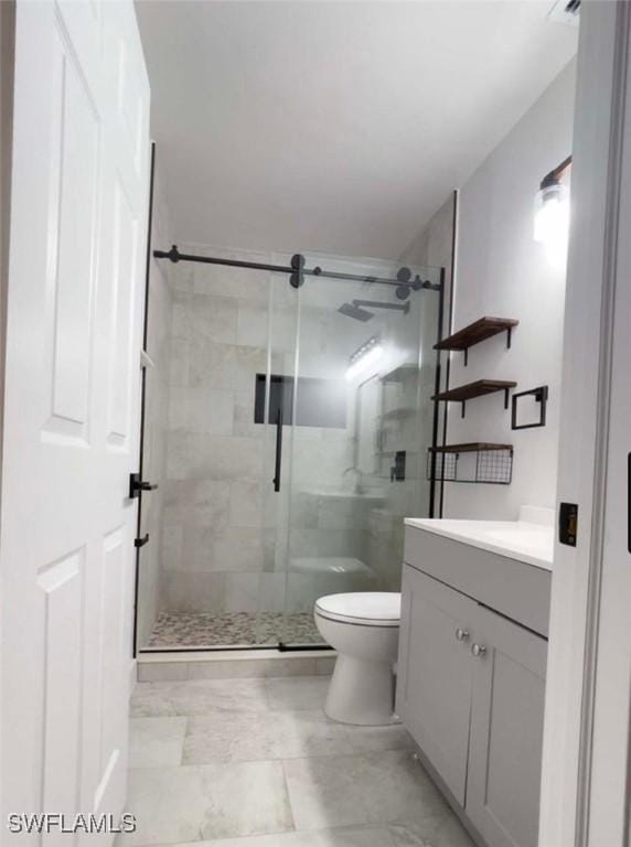 bathroom featuring walk in shower, vanity, and toilet