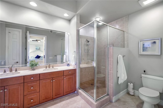 bathroom featuring vanity, toilet, an enclosed shower, and tile patterned flooring