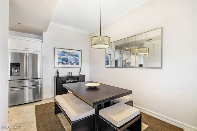 dining area with crown molding and light tile patterned floors