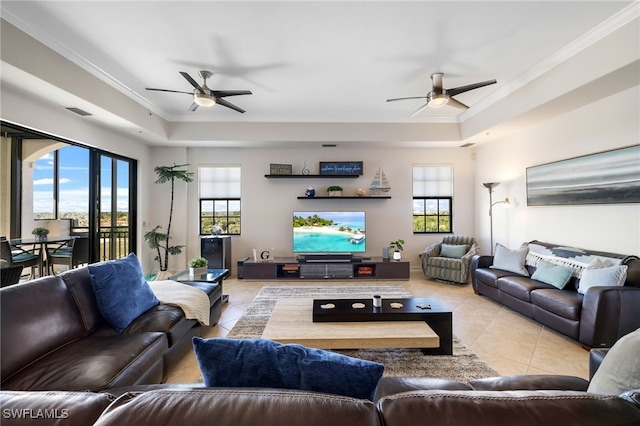 living room with crown molding, ceiling fan, plenty of natural light, and light tile patterned floors