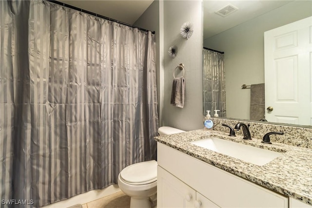 bathroom featuring vanity, tile patterned flooring, curtained shower, and toilet