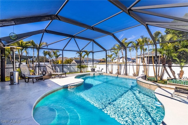 view of swimming pool with a patio and glass enclosure