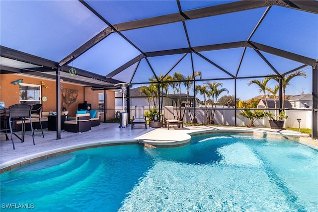 view of swimming pool featuring outdoor lounge area, a lanai, and a patio area