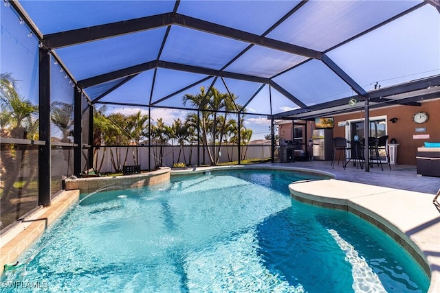 view of swimming pool with a lanai and a patio area