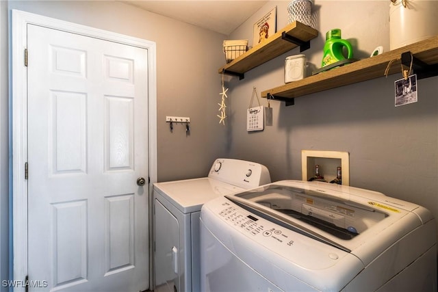 clothes washing area featuring separate washer and dryer