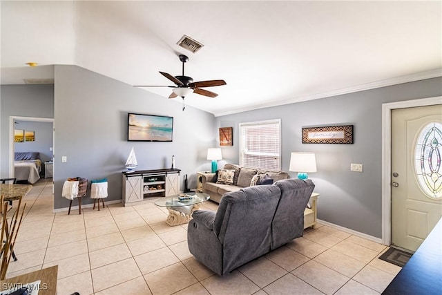 living room with light tile patterned floors, a wealth of natural light, and vaulted ceiling