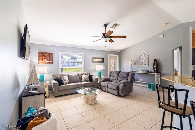 tiled living room with ceiling fan and lofted ceiling