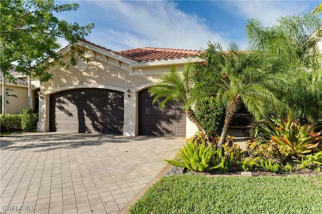 mediterranean / spanish house with a garage