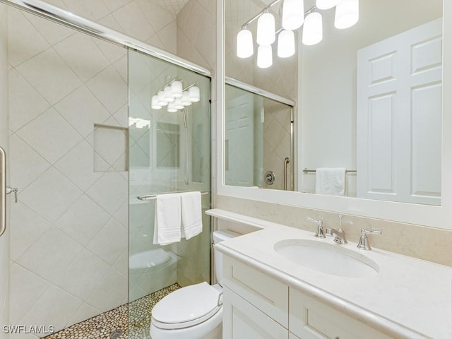 bathroom with vanity, toilet, and an enclosed shower