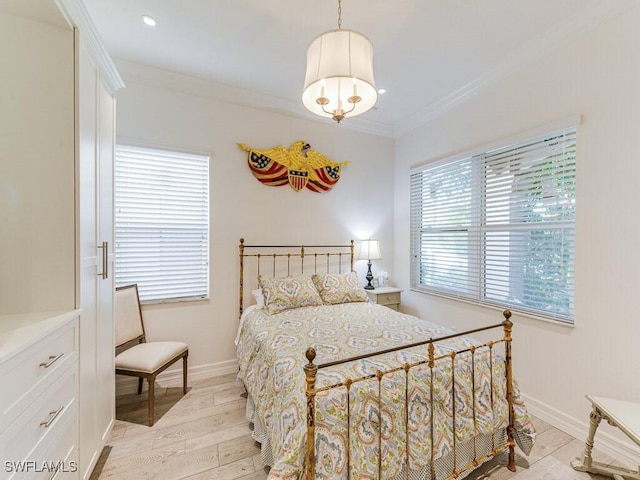 bedroom with ornamental molding and light hardwood / wood-style floors