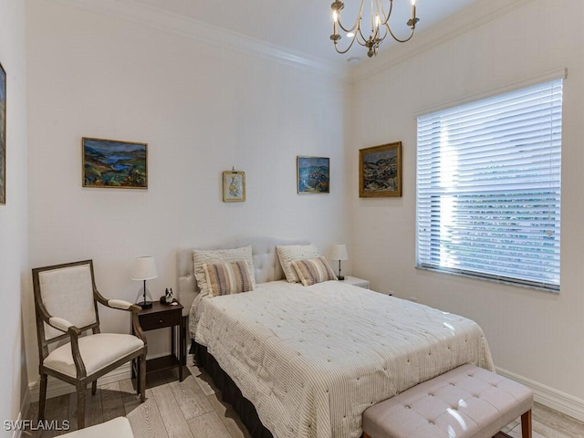 bedroom featuring crown molding, light hardwood / wood-style flooring, and a notable chandelier