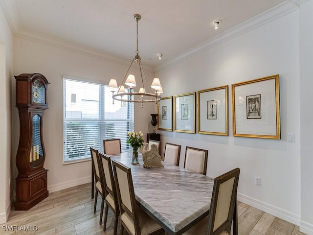 dining area with crown molding, a notable chandelier, and light wood-type flooring