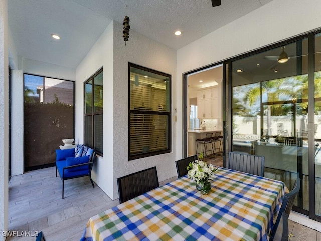 dining room featuring a textured ceiling and light wood-type flooring