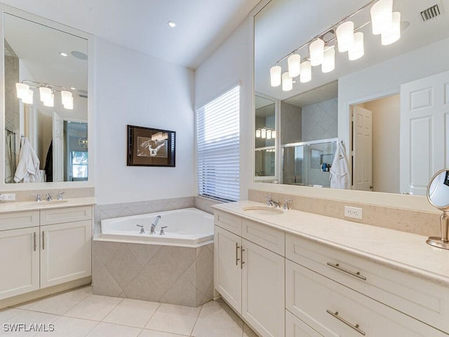 bathroom featuring vanity, shower with separate bathtub, and tile patterned flooring