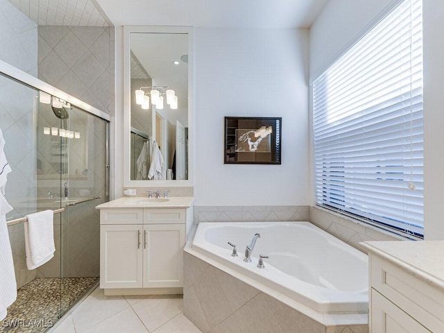 bathroom featuring independent shower and bath, vanity, and tile patterned floors