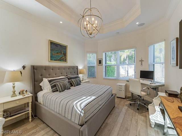 bedroom featuring crown molding, a notable chandelier, a tray ceiling, and light hardwood / wood-style flooring