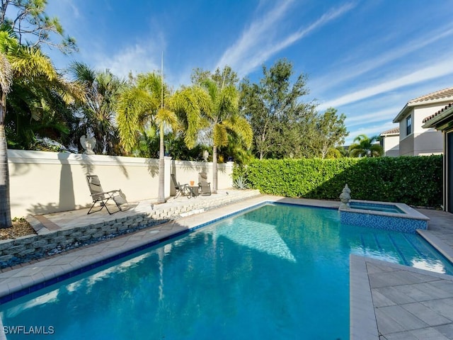 view of pool featuring an in ground hot tub and a patio area