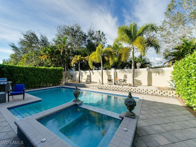 view of pool with an in ground hot tub