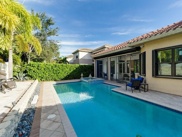 view of pool featuring a patio area and an in ground hot tub