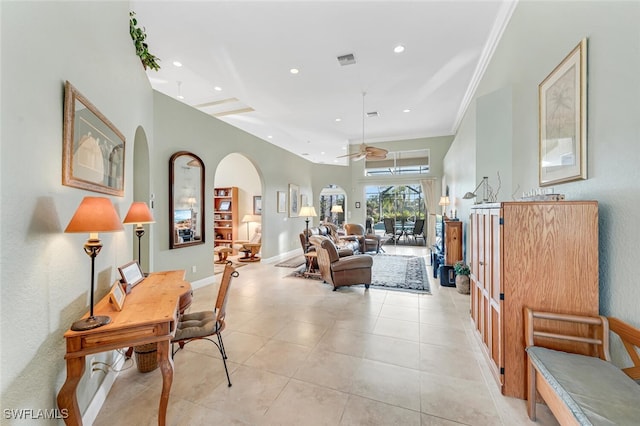 living room featuring light tile patterned floors, visible vents, arched walkways, ornamental molding, and recessed lighting