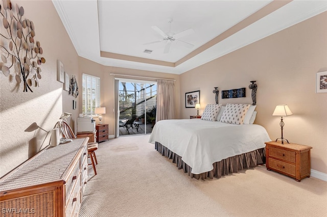 bedroom with access to outside, light colored carpet, a raised ceiling, and ceiling fan