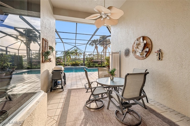 view of patio / terrace featuring ceiling fan and a lanai