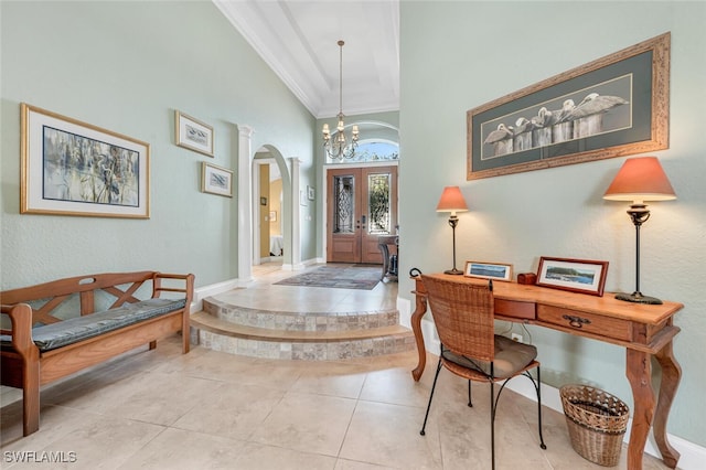 entryway with arched walkways, a towering ceiling, tile patterned floors, an inviting chandelier, and french doors