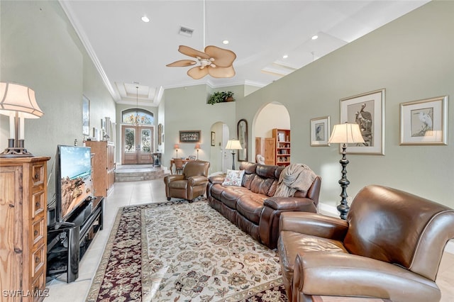 living room featuring ornamental molding, light tile patterned floors, and ceiling fan