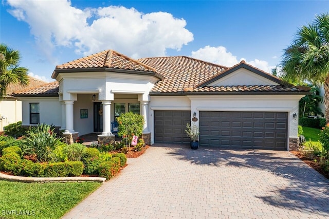 mediterranean / spanish home with a garage