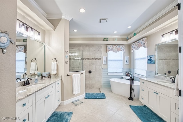 bathroom with tile walls, vanity, ornamental molding, tile patterned floors, and separate shower and tub